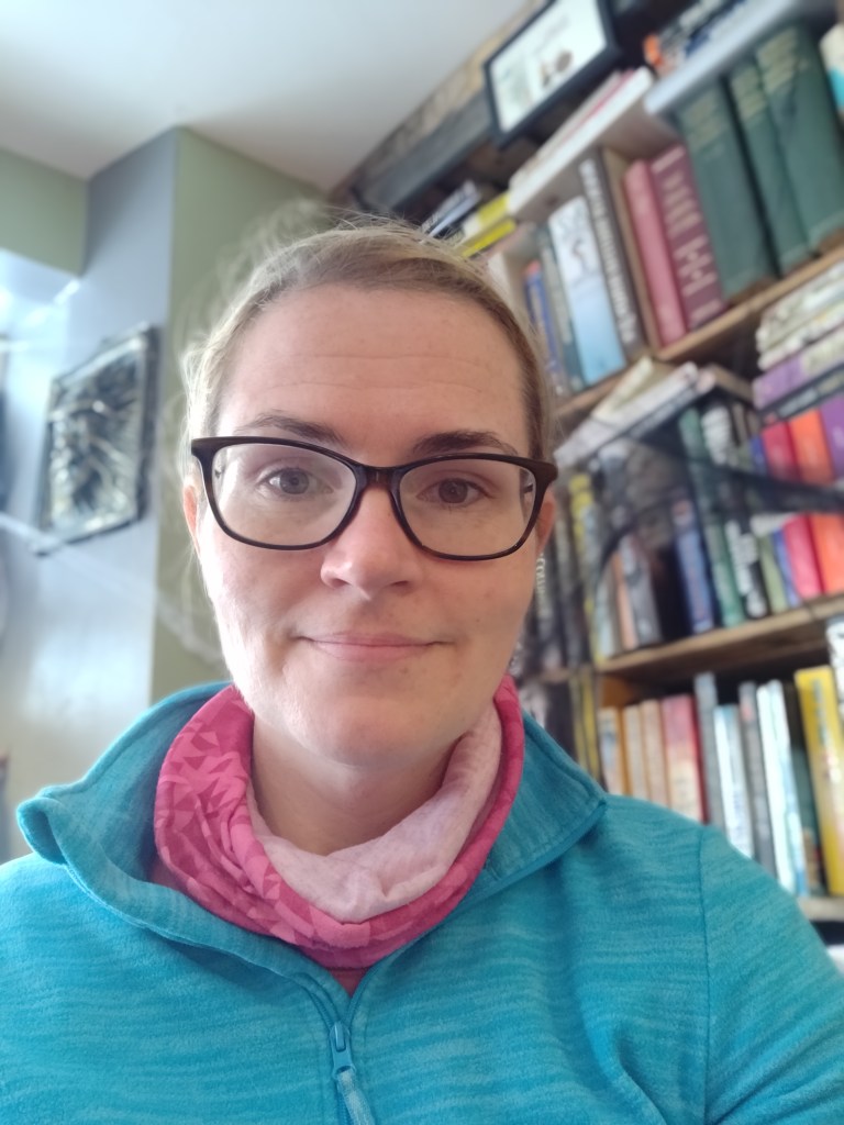 Claire in front of a bookcase